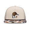 A beige trucker cap with a camouflage-patterned flat brim, featuring an embroidered pintail duck head on the front and a small brown AF logo.