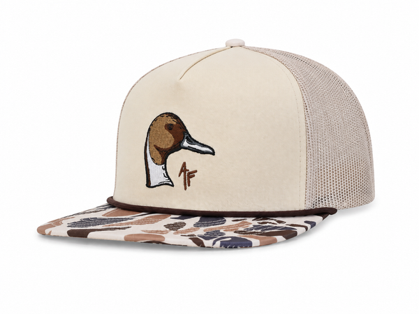 A beige trucker cap with a mesh back, featuring an embroidered duck head logo and a brown AF on the front. The flat brim has a brown, beige, and gray camouflage pattern.
