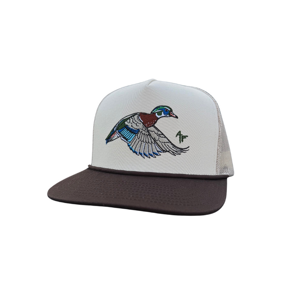 A trucker-style snapback cap featuring a white front panel with an embroidered woodduck design, a dark brown flat brim, and dark brown mesh back panels.