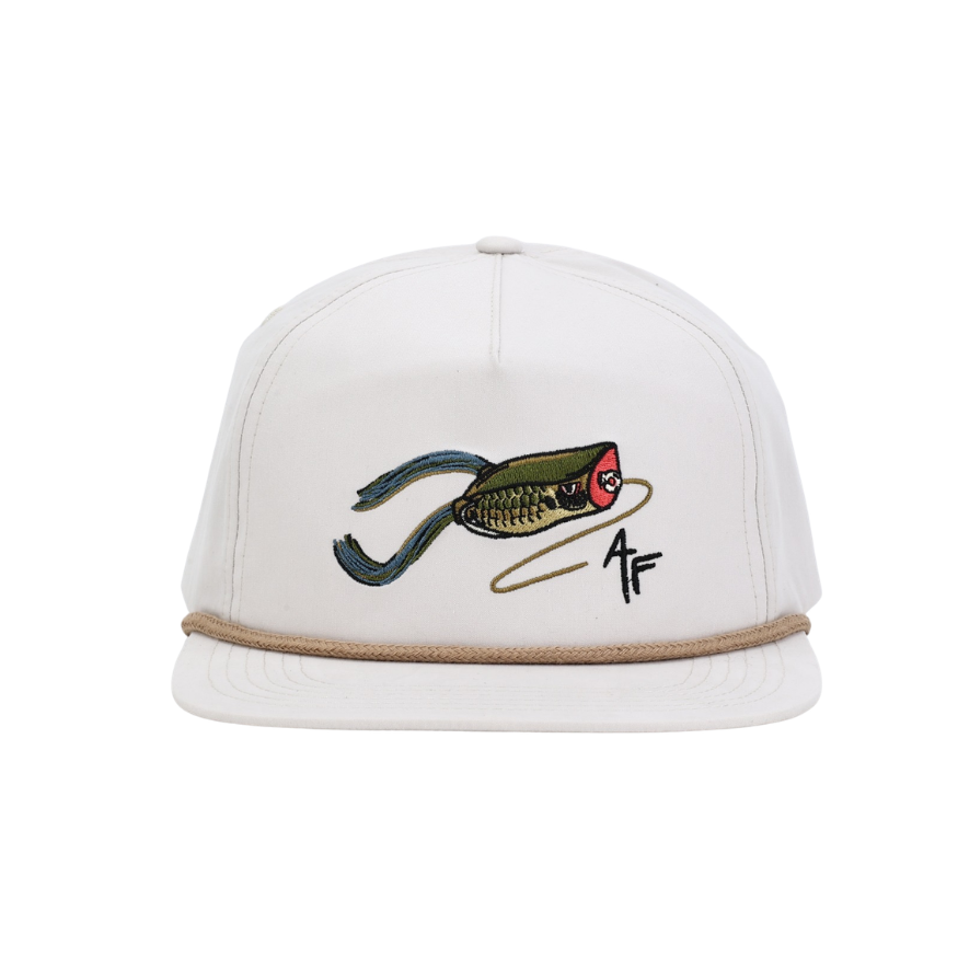 Cream hat with khaki rope. Frog fishing lure design with adjustable snapback.