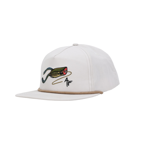 Cream cap with fishing lure design and logo on a white background