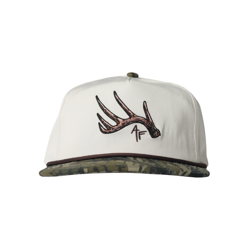 White cap with brown deer antler design on a white background