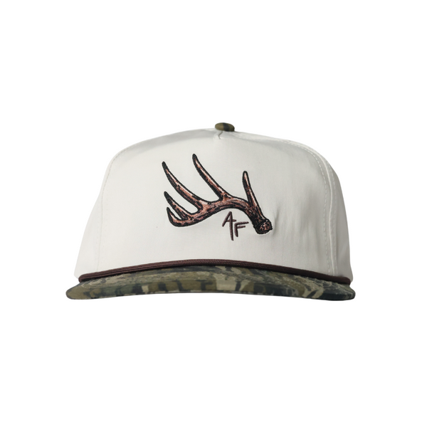 White cap with brown deer antler design on a white background