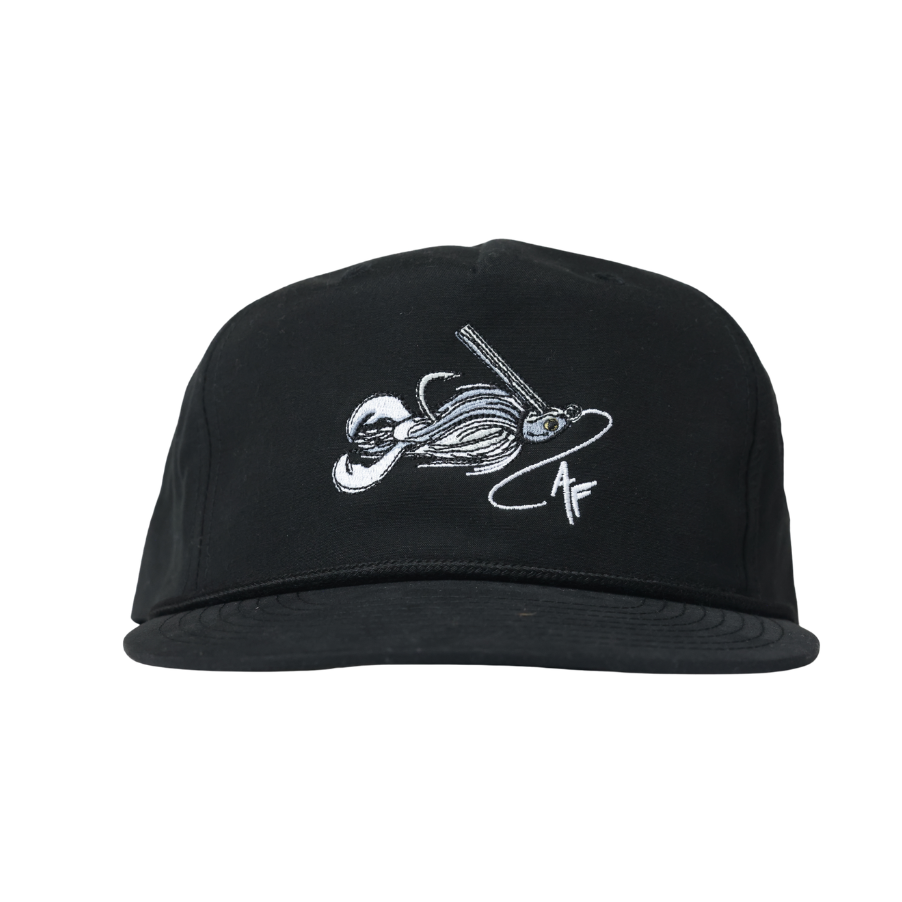 A black flat-brim cap with a white embroidered graphic of a fishing lure on the front, set against a plain white background.