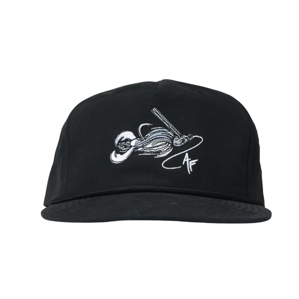 A black flat-brim cap with a white embroidered graphic of a fishing lure on the front, set against a plain white background.