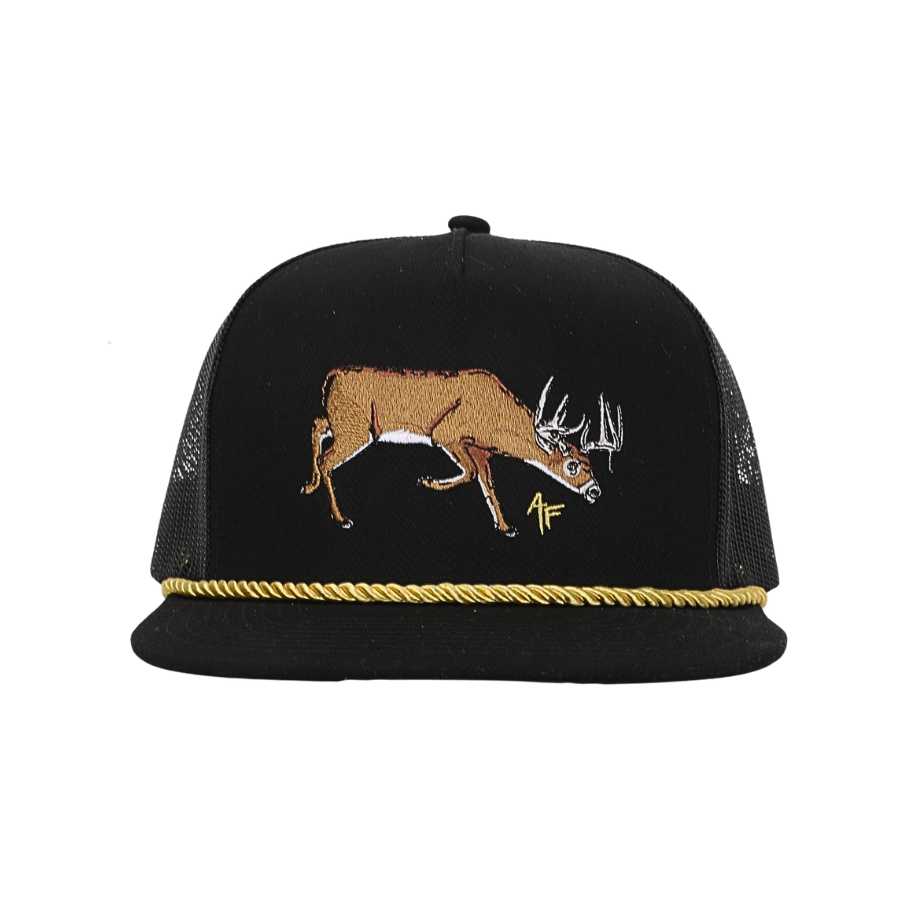 A black trucker hat with a brown embroidered deer on the front, a gold rope trim along the brim, and black mesh side panels, shown against a plain white background.