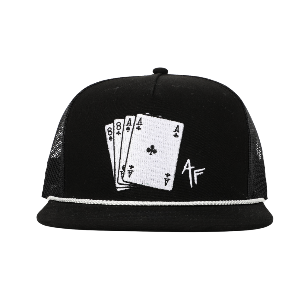 A black trucker-style cap with a white embroidered design on the front depicting four poker cards and a stylized 'AF' monogram, set against a plain white background.