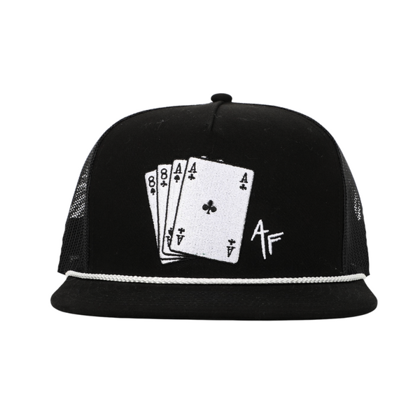 A black trucker-style cap with a white embroidered design on the front depicting four poker cards and a stylized 'AF' monogram, set against a plain white background.