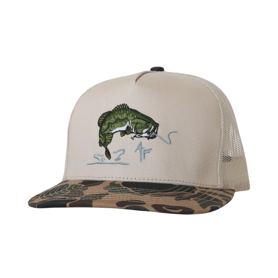 A beige trucker hat with a green bass fishing graphic on the front and a camouflage-patterned visor, shown against a plain white background.