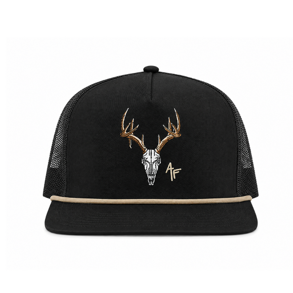 A black trucker hat with a flat brim, black mesh back panels, and a central embroidered design of a deer skull with antlers and a small 'AF' monogram.
