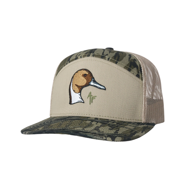 A trucker-style cap with a beige front panel, camouflage patterned front panels and brim, and beige mesh back panels. The front panel features an embroidered pintail duck head logo with a small green AF' mark.