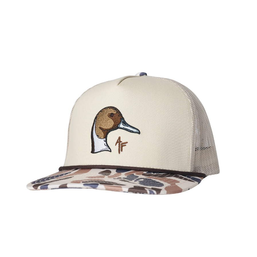 A trucker-style cap with an off-white front panel, a pintail duck head embroidery on the front, and a brown camouflage-patterned visor, shown against a plain white background.