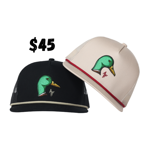 Two baseball caps shown on a plain white background, one black and one off-white, both with a green duck head logo and a red accent stripe. A black '$45' text overlay appears above the hats.