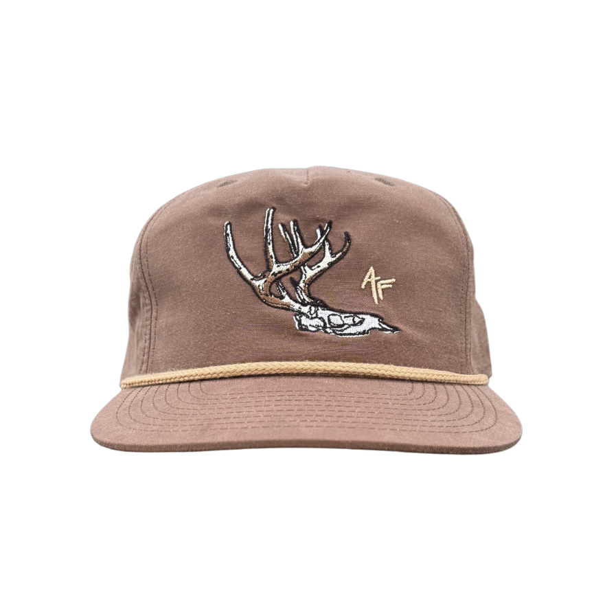 Brown soft hat with light brown rope with a deer skull design that has AF acronym
