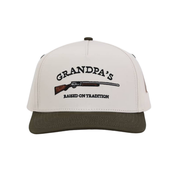 Cream hat that says "grandpa's raised on tradition with a smoke pole design" hand me down.