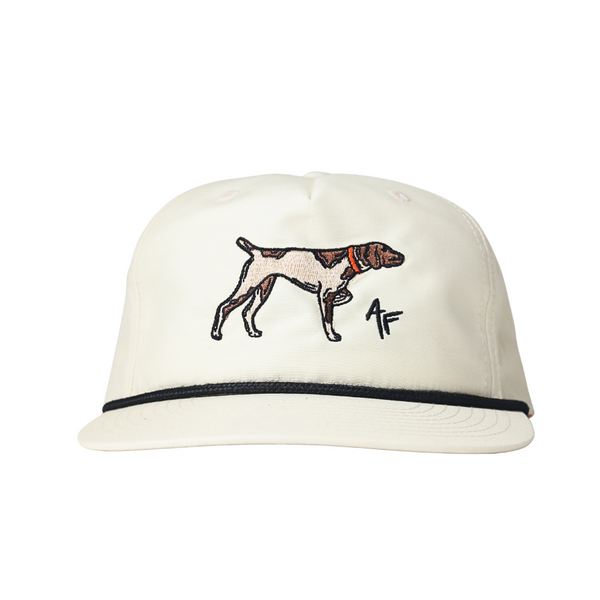 An off-white/cream snapback cap featuring an embroidered hunting dog and a stylized 'AF' logo on the front, with a thin black stripe along the brim.
